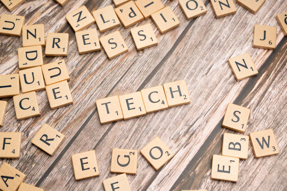 Wooden Scrabble tiles spelling TECH on a textured surface, showcasing creativity