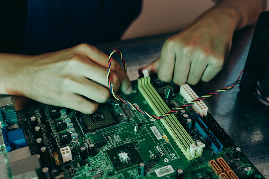 Person assembling computer motherboard