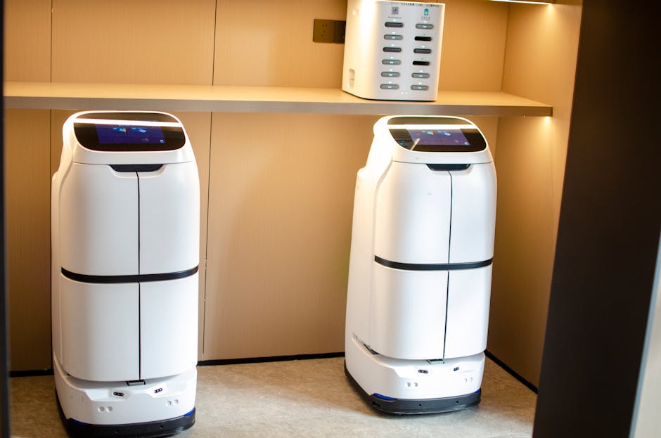Two white robotic delivery systems in a modern indoor room