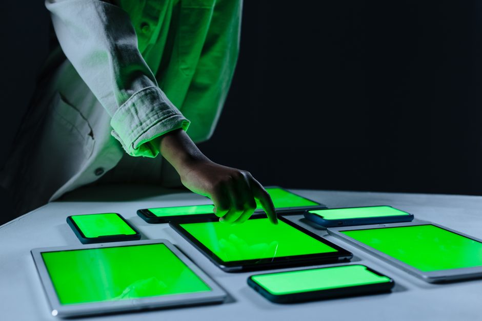 Hand interacting with multiple digital tablets